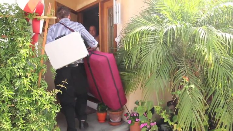 alma-myers-carrying-equipment-doorway-back